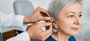 mature woman getting hearing aids at a hearing clinic